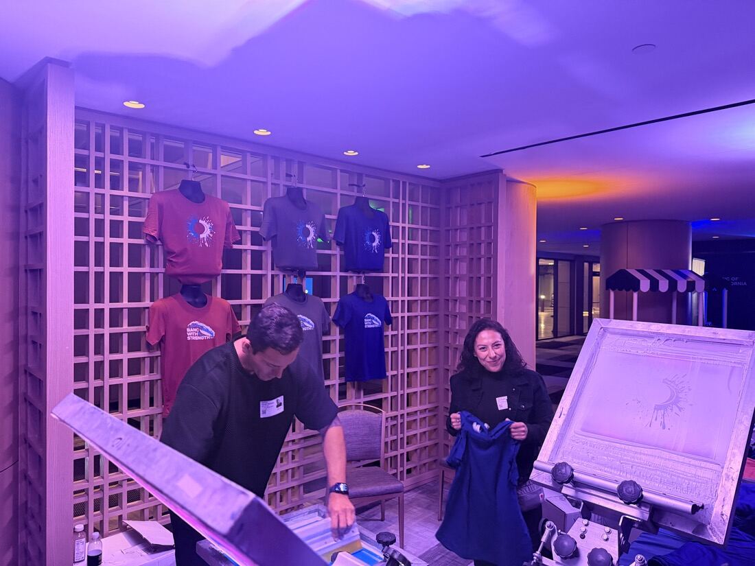 Garment display wall and live station set up inside a hotel event space