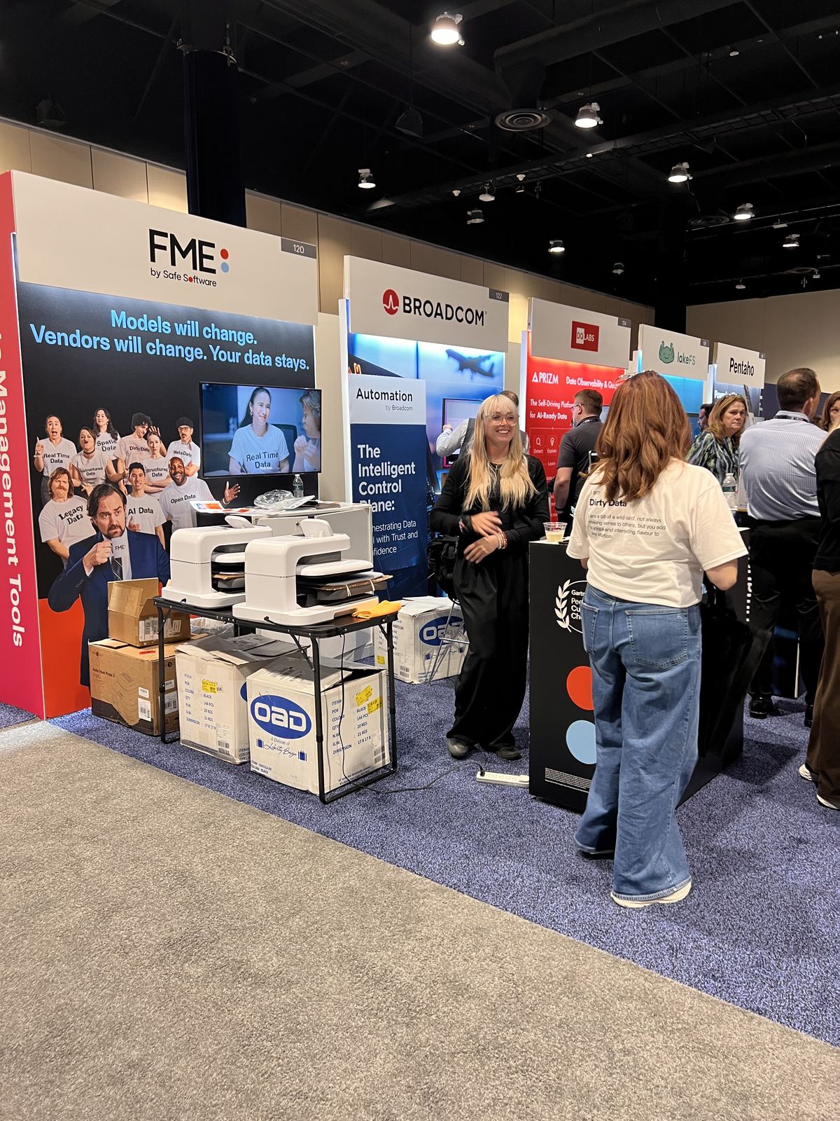Trade show booth with tabletop personalization equipment drawing attendee traffic